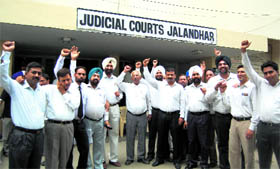Lawyers hold a demonstration against conducting of evening courts in Jalandhar on Friday.