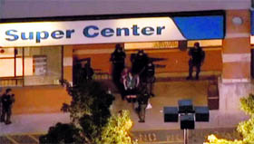 Police officers stand guard outside Pathmark supermarket after a shooting incident in New Jersey.