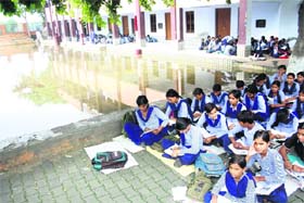 Diving school: Due to lack of sitting arrangement for students during the monsoon season girls were forced to sit besides a tank in a government school of Sangi village in Rohtak