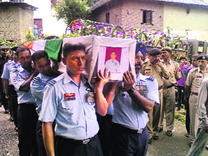 Mortal remains of Wing Commander Ashish Sharma being carried to the cremation ground by a contingent of the Indian Air Force at Palampur on Saturday. 