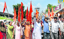 Members of the Dogra Front and the Shiv Sena raise slogans against the Kashmir interlocutors condemning their report outside the exhibition ground in Jammu on Saturday