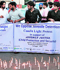 Civil society members during a candlelight protest in Srinagar