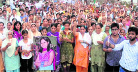 Protesting residents take part in a candlelight march in Jalandhar on Saturday.