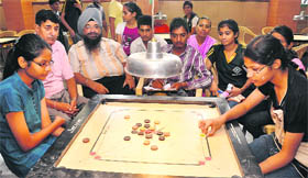 Players in action during a carrom tournament at St Stephens School in Chandigarh on Sunday.