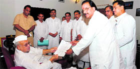 Leader of the Opposition in the state Assembly Ajay Bhatt submits a memorandum to Governor Aziz Qureshi at Raj Bhavan in Dehradun on Sunday.