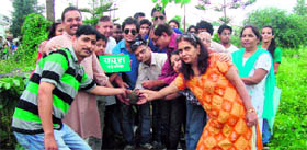 Members of Kaash, a voluntary group, participate in a tree plantation drive near the THDC colony at Mothrowala in Dehradun on Sunday.