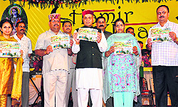 PK Dhumal releases a souvenir in Hamirpur on Saturday night.