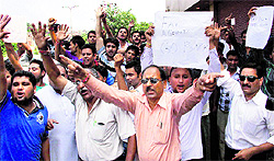 Activists of the Bharatiya Janata Yuva Morcha and Panun Kashmir shout slogans during a protest against former interlocutors meeting with members of the civil society in Jammu on Sunday