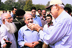 Union Minsiter for New and Renewable Energy Farooq Abdullah interacts with ground staff during his surprise visit to a playground in Srinagar on Sunday