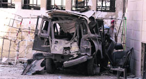 The wreckage of a vehicle is seen after an explosion near major military and security compounds in Damascus on Sunday. 