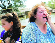 A woman cries as she sees her flooded home for the first time since Hurricane Isaac hit Braithwaite. 
