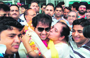 An elderly relative welcomes Vipul with a kiss in Amritsar on Monday.