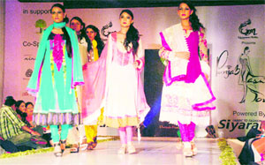 Models walk the ramp during Punjab Fashion Tour organised by the Nanhi Chaan Foundation at a hotel in Amritsar on Sunday. 