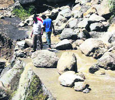 Boulders lie on the road to Ghansali in Tehri Garhwal following heavy rain and flash floods on Monday.