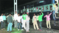 Passengers of the Ferozepur Express wait at the Islamia railway station in Rohtak district following a blockade by villagers on Sunday night. Photo: Manoj Dhaka