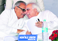 Chief Minister Bhupinder Singh Hooda and Union Minister Kapil Sibal discuss a point at the launch of a pilot project on vocational education in Gurgaon on Monday. Tribune photo:Sayeed Ahmed