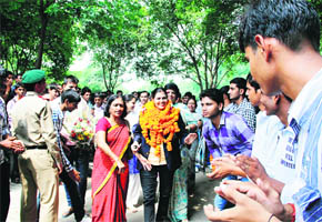 Indian Womens Kabaddi Team Coach Sunil Dabas, recipient of the Dronacharya Award, is welcomed by her colleagues and students at Dronacharya Government PG College in Gurgaon.