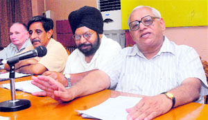 Retired teachers from DAV institutions hold a press conference in Jalandhar on Monday.
