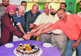 Alumni of St George’s College, Mussorie, cut a cake during a launch of the Punjab chapter of the alumni association of the school