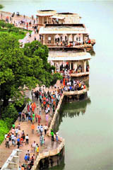 People take a view of the flooded Anna Sagar Lake in Ajmer on Monday.