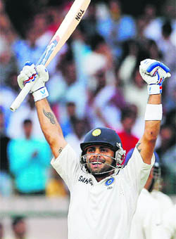 Virat Kohli celebrates after India won the second Test and the series 2-0 against New Zealand on the fourth day of the second Test in Bangalore on Monday. Set a target of 261, the Indians were in a spot of bother at 166 for five at one stage before Kohli and skipper M S Dhoni steered the team home with an entire day to spare. 