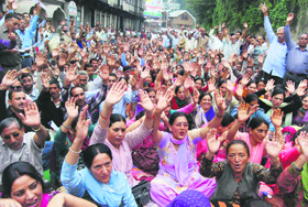 Members of the State Electricity Board Employees Union raise slogans at the Secretariat in Shimla on Tuesday.