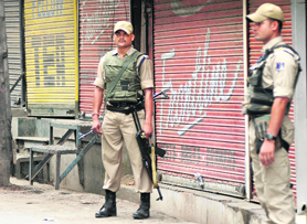Security personnel stand guard in the Lal Chowk area in Srinagar on Tuesday.