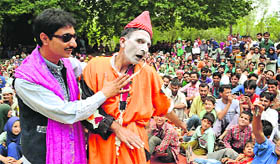 Artistes enact a scene from a play in Bandipore on Tuesday.