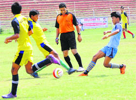 Players in action during a football match at Bakshi Stadium in Srinagar on Tuesday.