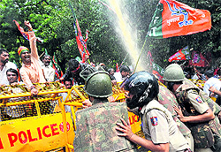 Protesting for statehood: Pro-Telangana BJP activists brave water-cannons during a protest in support of statehood for Telangana, in New Delhi on Tuesday
