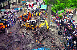 Rescue work in operation after a portion of the metro rail project collapsed on the Andheri-Kurla road in Mumbai on Tuesday