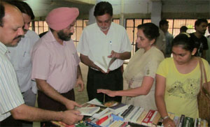 PTU GZS Director Dr Jasbir S Hundal and Dean, CUP, Prof Paramjit Singh Ramana discuss the books at an exhibition organised on the campus.