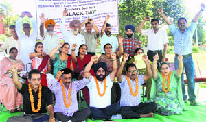 Members of the UT Cadre Educational Employees Union observe a strike at the rally ground, Sector 25, in Chandigarh on Wednesday. 