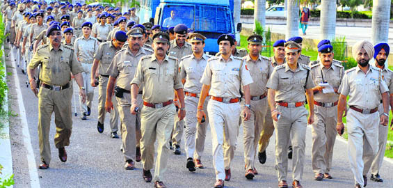 Police personnel during a flag march on the Panjab University campus in Chandigarh on Wednesday.