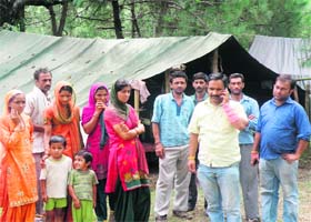 Displaced Tali residents live in tents near Khudian in Kangra district