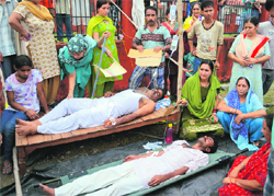 Residents on hunger strike in the migrant township of Jagti. Tribune photo 