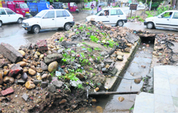 A dug-up drain at the main market in Channi area has been causing inconvenience to residents and local traders. Tribune photo: Anand Sharma