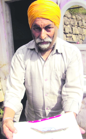 A resident showing the recovered reptile from a tap in Batote. Photo by writer