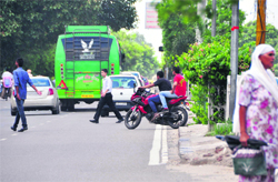 A two-wheeler rider crosses a road divider in Ludhiana. Tribune photo: Himanshu Mahajan 