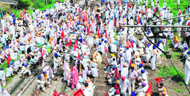 Members of various farmer and labour unions block rail traffic in Amritsar on Wednesday