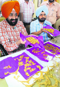 Commandant, IRB, Mandeep Sidhu showing the 2.4 kg of gold recovered from one Rampal, a resident of Meerut, in Patiala on Wednesday