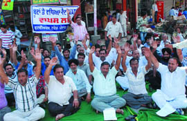 Footwear traders stage dharna near Sadbhawna Chowk in Bathinda on Thursday. 