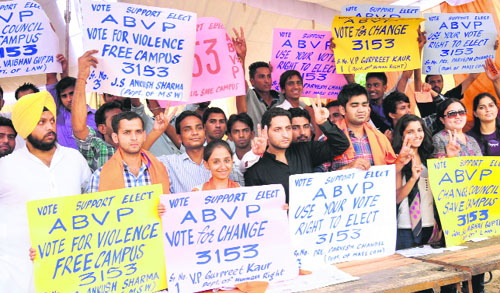 Supporters and candidates of the ABVP pose in their tent at Panjab University.