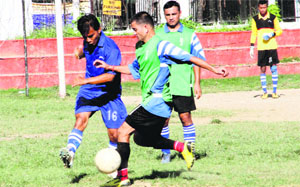 A match in progress during the Lala Nemi Dass Memorial District Football League in Dehradun on Thursday. 