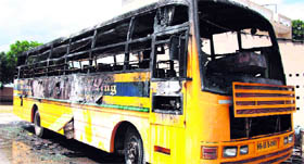 A Khetawas Dronacharya College bus torched by protesters on Thursday.