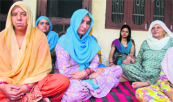 Aman Kumars mother Pushpa Devi is consoled by women at her house at Kardial village in Kangra on Thursday. Photo by writer