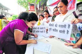 Women participate in a signature campaign organised by the BJP Mahila Morcha join Jammu