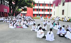 Girl students sit on ground due to lack of proper sitting arrangement at the Government Women College, Parade, in Jammu
