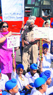 Students and faculty of Sri Guru Harkrishan Senior Secondary Public School lodge protest demanding repair of road stretch on the Sultanwind Link road in Amritsar on Friday.