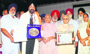 Schoolteachers with their mementos during a felicitation ceremony in Amritsar on Friday. 